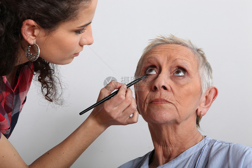 妇女对一位年长的女士进行化妆剧院皱纹工具公民女性老年后台戏剧艺术家皮肤图片