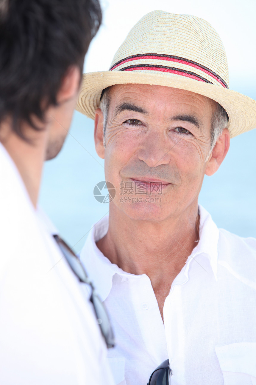老年男子的肖像享受乐队黑色太阳帽领带关系红色白色时间稻草图片