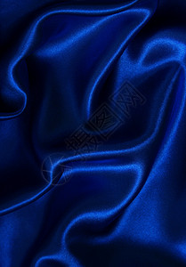 平滑优雅的蓝色丝绸材料海浪织物布料曲线折痕投标纺织品银色背景图片