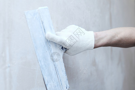 石膏手坐标对齐墙壁水泥修理石膏活动补丁维修材料火花男人建设者背景