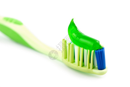 草本牙膏与隔离的绿牙膏同牙刷背景
