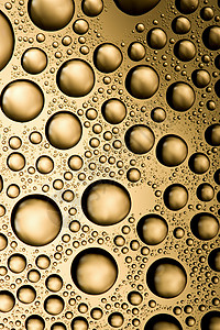 金色水滴背景瓶子环境水分雨滴流动玻璃金子液体宏观窗户背景图片