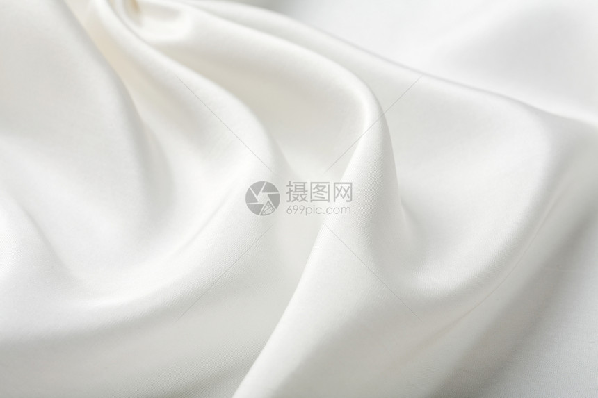 抽象白色丝绸背景纺织品涟漪材料生产曲线折叠布料织物衣服组织图片