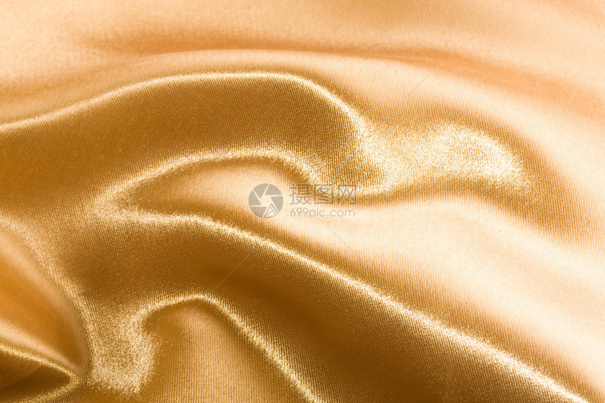 金色缎面涟漪黄色纺织品布料丝绸材料折痕织物曲线奢华图片