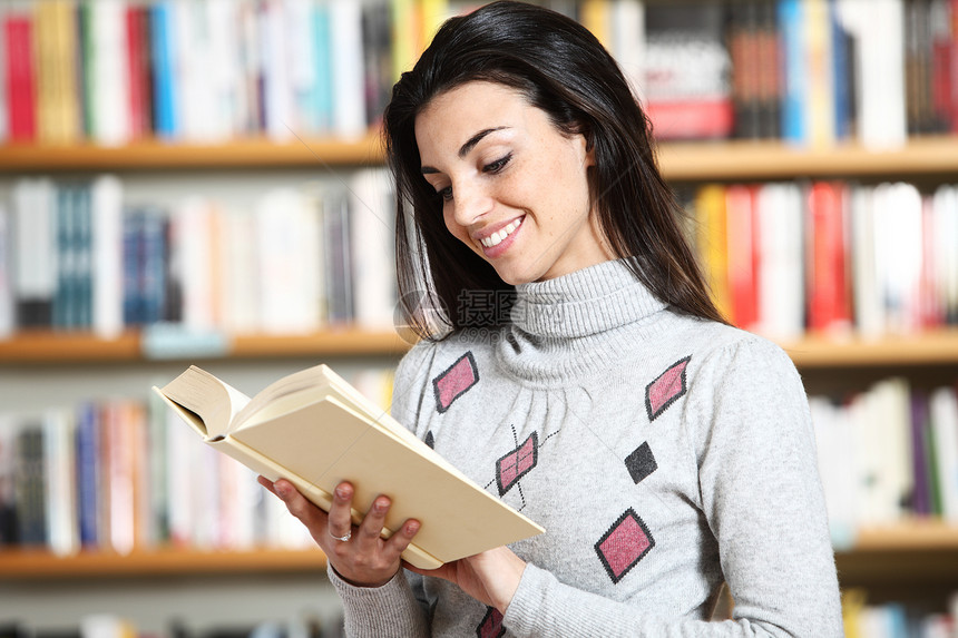 书在书店里手头拿着书籍 微笑着笑着的女学生图书馆女士校园女孩青少年科学文学青年书柜知识图片