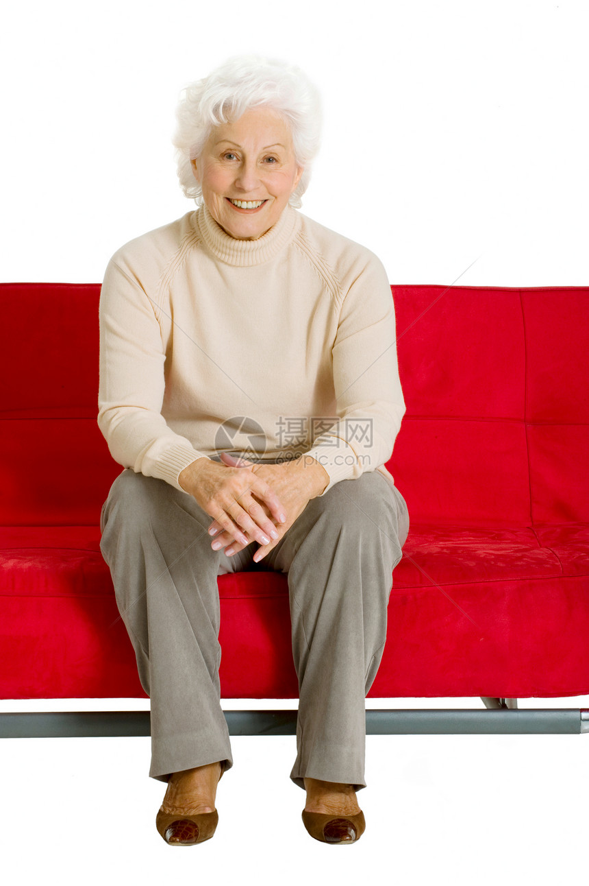 坐在沙发上的老年妇女休闲装家庭生活微笑幸福红色白色图片