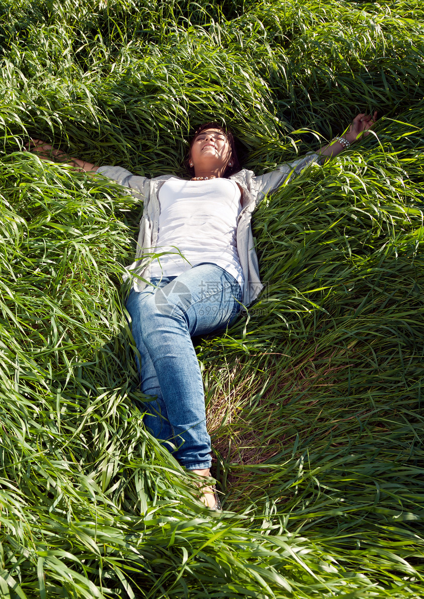女孩躺在青绿的草地上图片