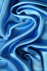 平滑优雅的深蓝丝绸丝绸纺织品折痕投标曲线银色织物海浪布料材料背景图片