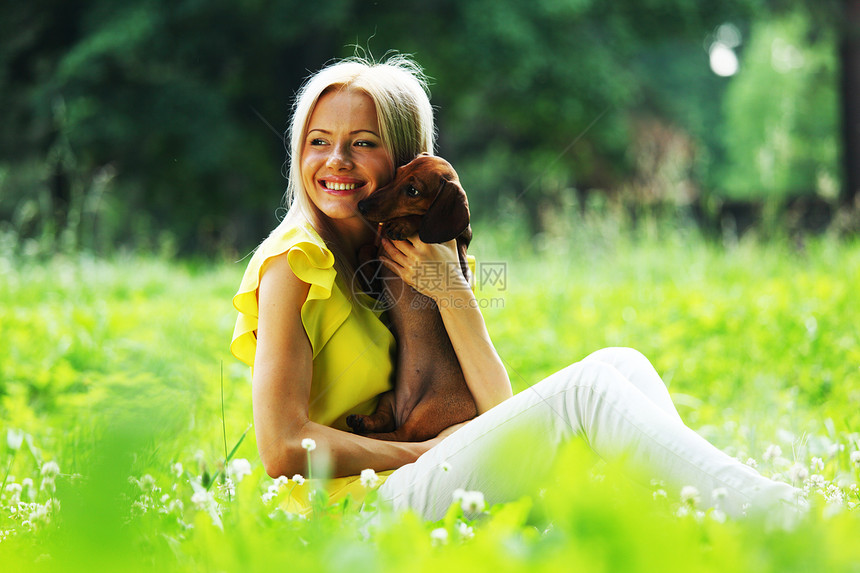 在她的怀里 有达赫松德的女子犬类拥抱香肠女性金发宠物爪子成人女士动物图片