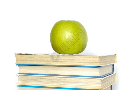 堆叠的书本教育水果生产白色绿色图书生活学校背景图片