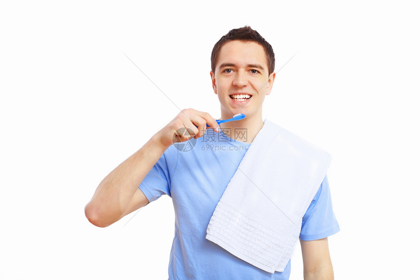 在家刷牙的年轻人蓝色牙齿牙膏幸福男人金发头发卫生男性刷子图片