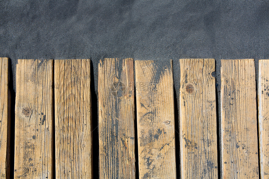 黑沙滩沙沙和木地板木板海滩地板宏观古董码头硬木火山木头控制板图片