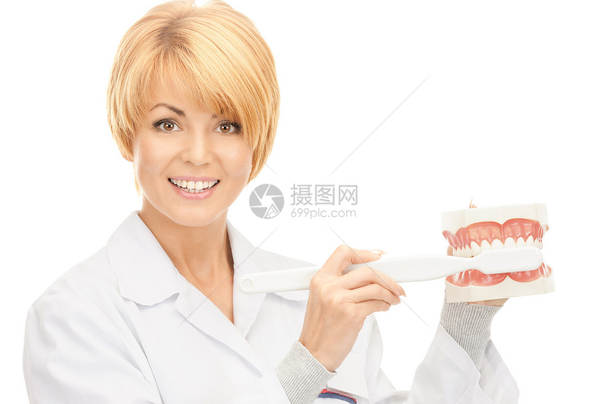 有牙刷和下巴的医生保健中年药品微笑刷子牙医打扫假牙牙齿女士图片