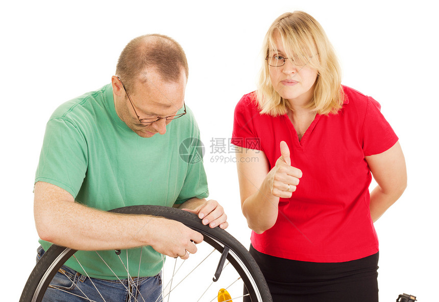 修理自行车车轮的机械工拆卸挑衅工作女士专注服务内胎交换前轮修理工图片