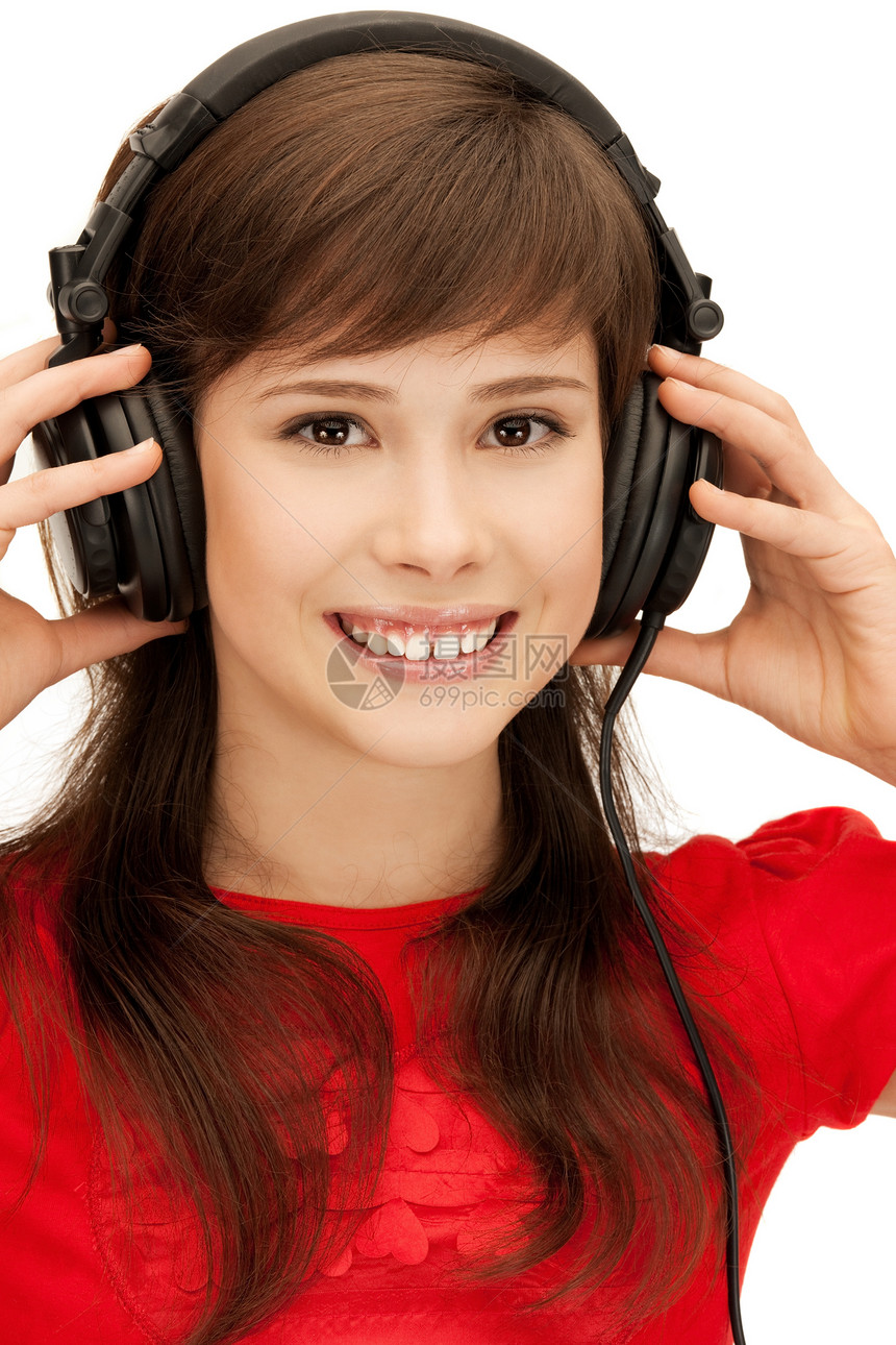 使用大耳机的快乐少女乐趣喜悦闲暇音乐播放器幸福听力女性耳机微笑青少年图片