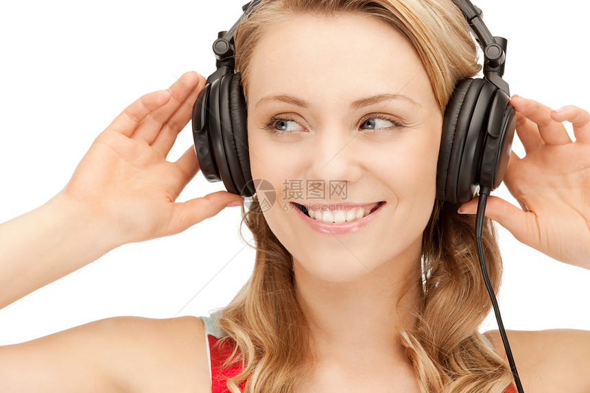 使用大耳机的快乐少女听力喜悦享受幸福微笑女性音乐播放器青少年乐趣闲暇图片