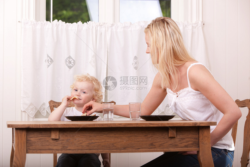 母子吃饭午餐妈妈儿子女士童年父母微笑食物桌子小吃孩子图片