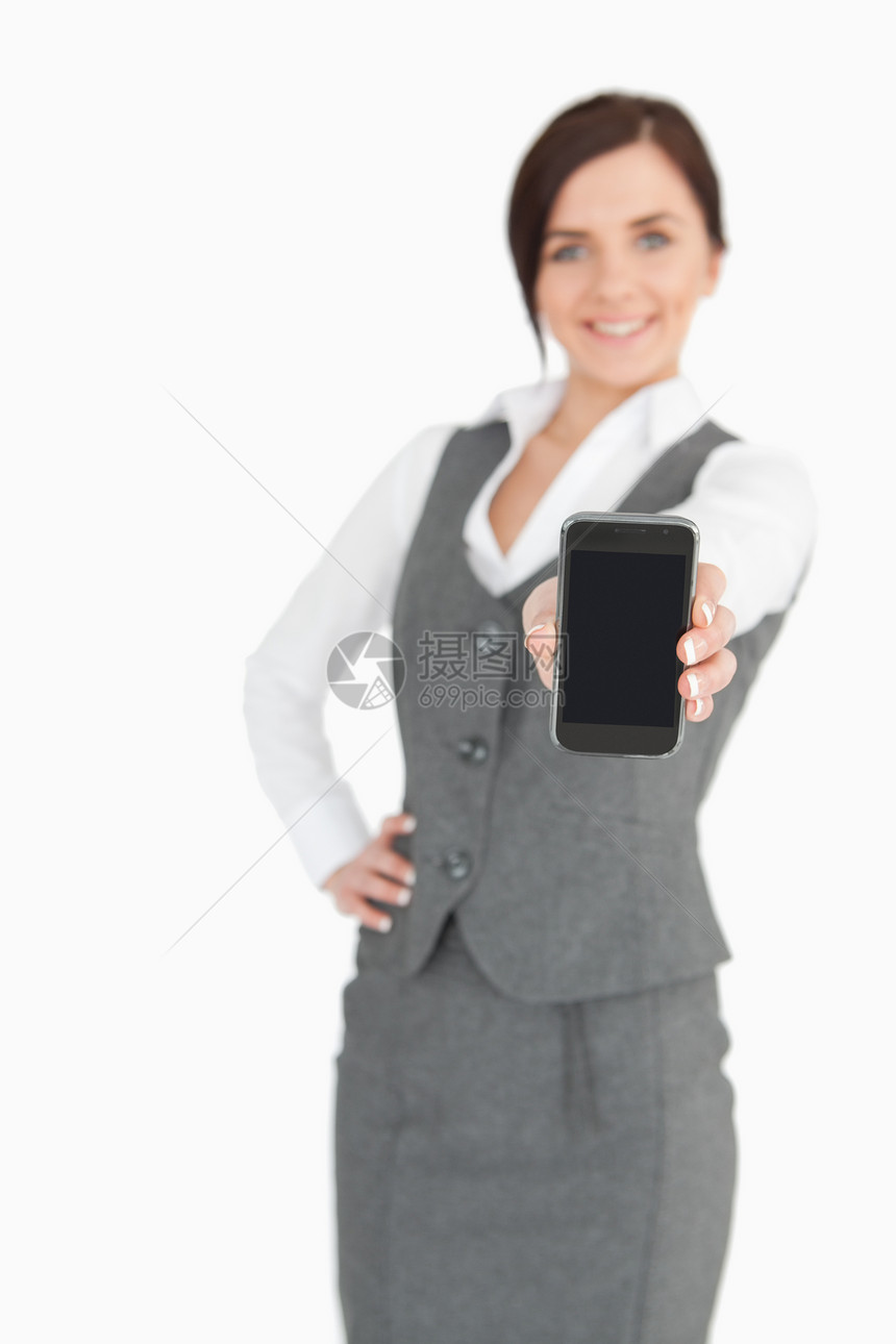 迷人的女商务人士在她的智能手机屏幕上露面图片