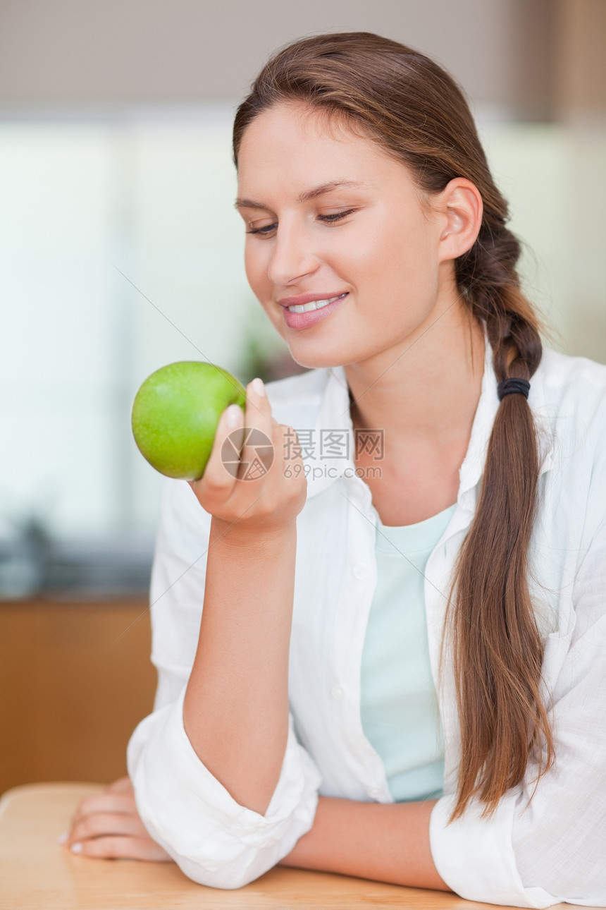一个带着苹果微笑的女人的肖像图片