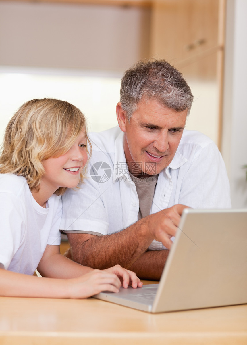父亲和儿子在笔记本电脑上图片