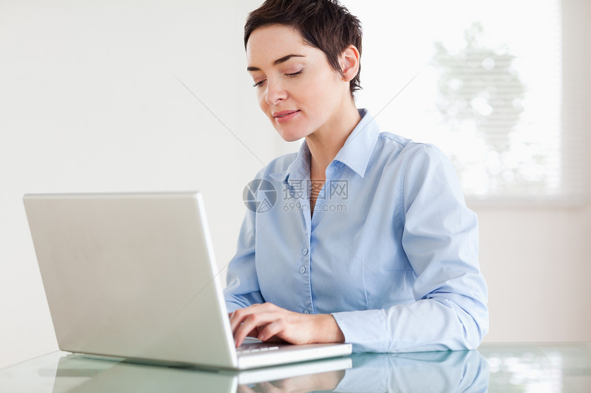 带着笔记本电脑的迷人短头发女商务人士图片