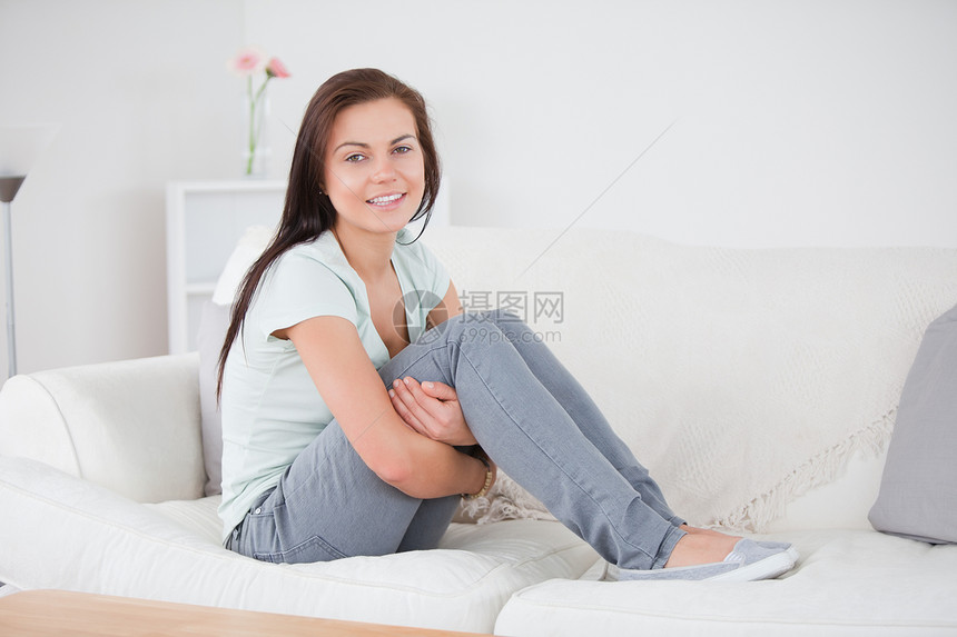 近距离靠近一个年轻女人 摆在她的沙发上图片