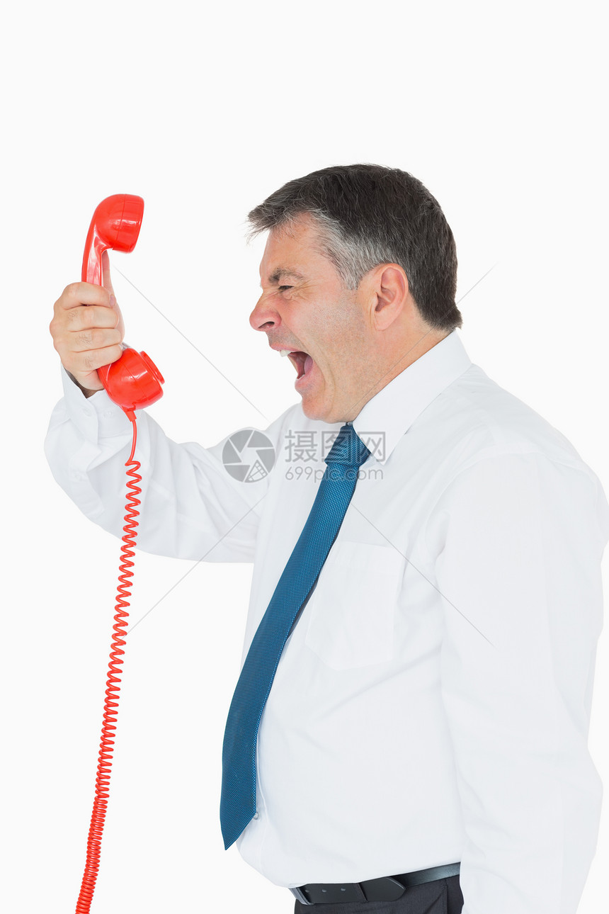商务人士在听筒上直接尖叫着生意人愤怒红色人士短发领带烦躁商务男性固定电话图片