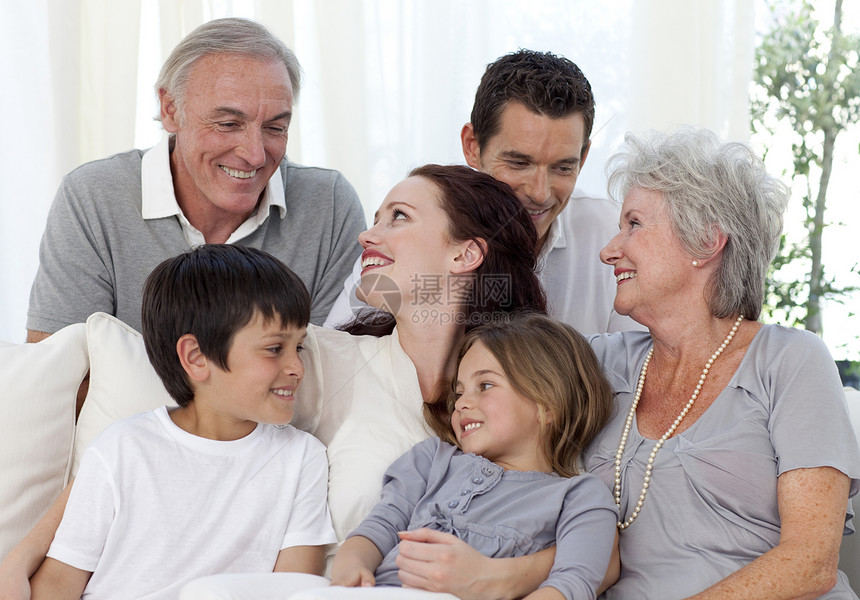 坐在沙发上的家庭肖像男性男生孙子拥抱妈妈房间女性孩子们父亲男人图片
