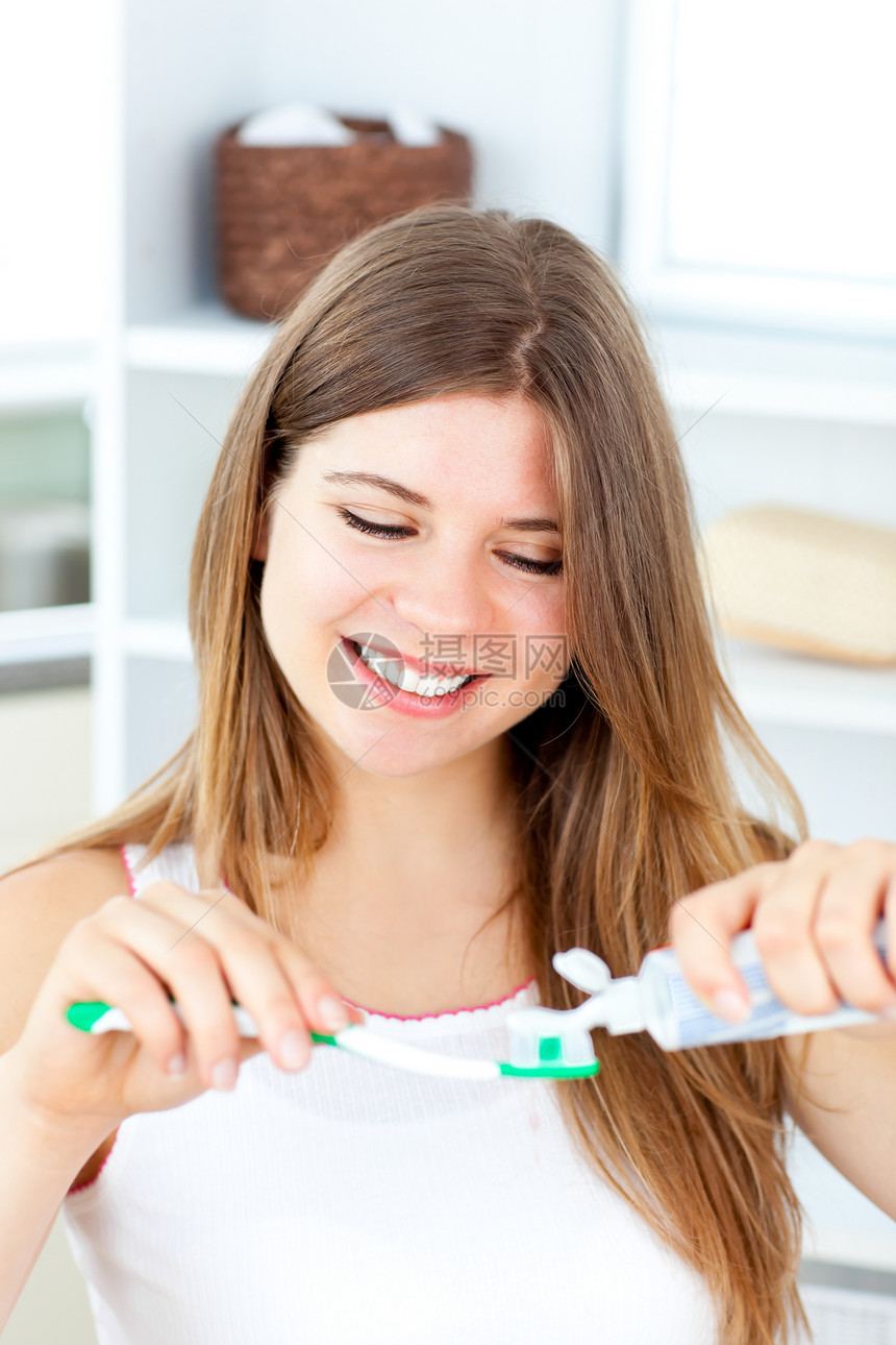 在洗手间用牙膏的快乐女人图片