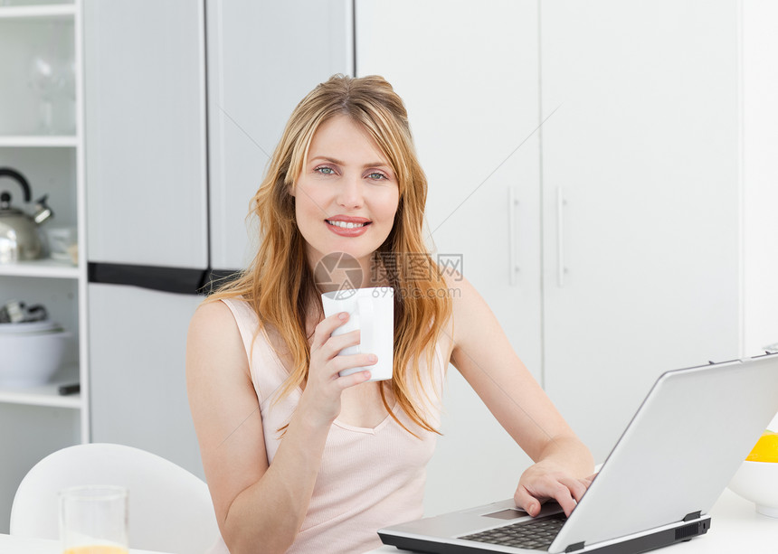 在厨房里喝咖啡的女子图片