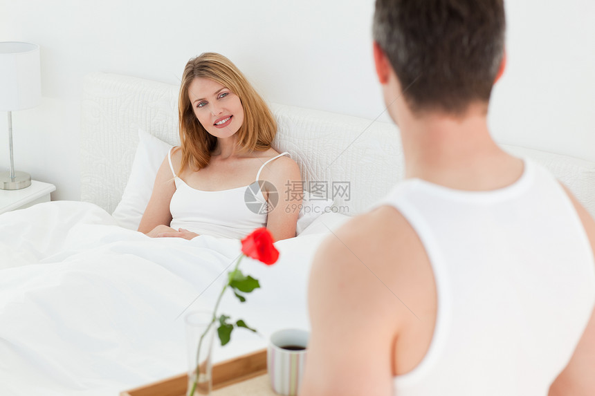 快乐的情侣在床上吃早餐幸福卧室夫妻投标说谎男性妻子女性黑发房子图片