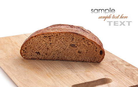 面包在切割板上烘烤白色黑色食物面粉木板糕点包子背景图片