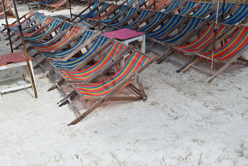 雨伞下木制海滩椅图片