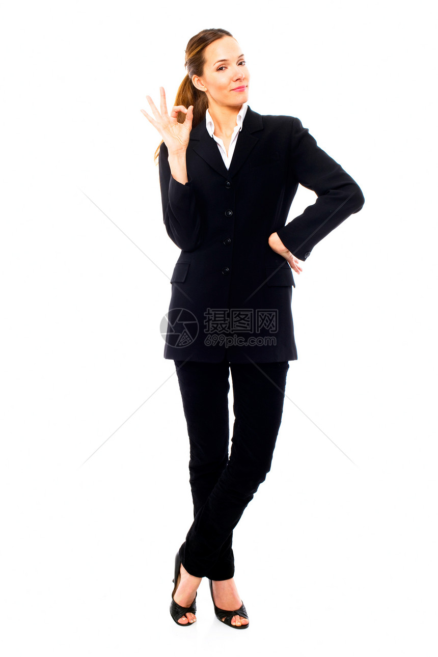 年轻女商务人士用她的手在白色的背黑锅上表示可以女性长发工作高跟鞋人士商业棕色女士员工年轻人图片