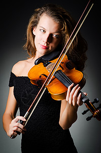 女孩拉大提琴在暗房里拉小提琴的女人细绳手指演奏家演员木头小提琴家作品艺术家提琴手旋律背景