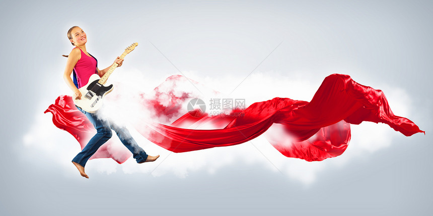 女青年玩电吉他和跳跳女性跳跃飞行舞蹈活力空气音乐家乐队乐趣旋律图片