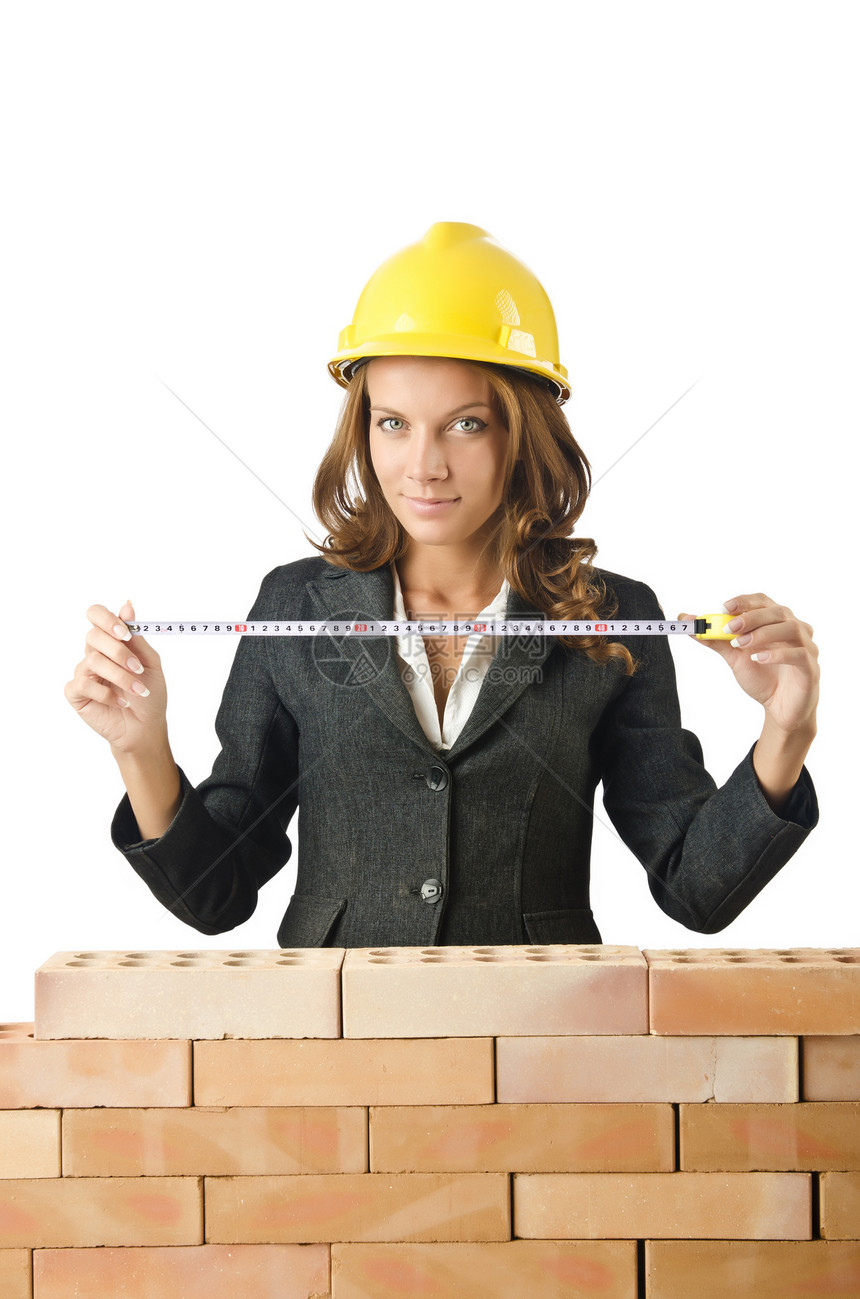 砖墙附近的女建筑师石头职业抵押测量工人头盔厘米建设者文件夹安全帽图片