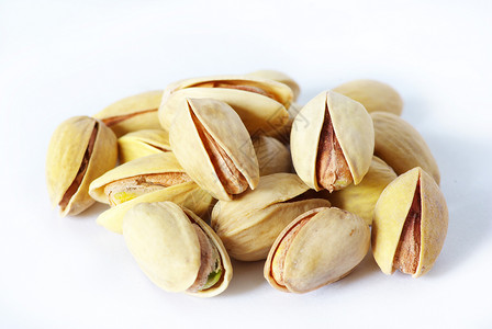 Pistachios 螺旋藻核心坚果小吃核桃开心果植物市场健康种子花生背景图片