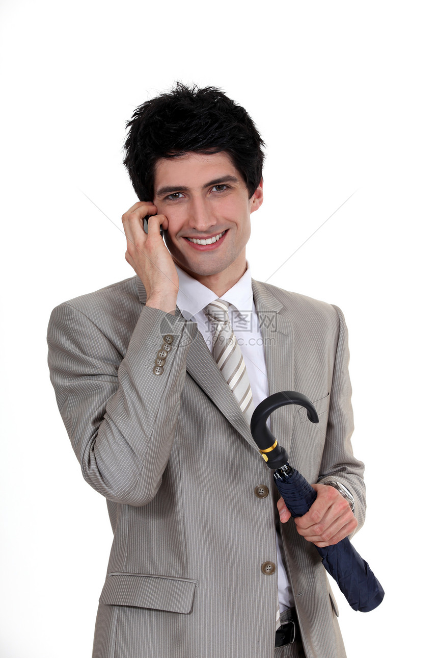 持伞子和用手机说话的商务人士;在电话上发言图片