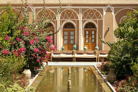 以hazd iran为家用池塘的旅馆室内花园酒店花朵背景图片