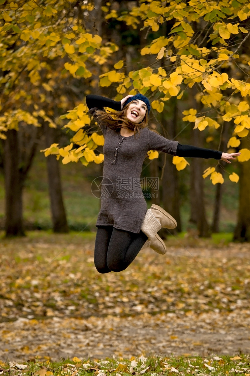 跳跃成人女孩公园女性喜悦快乐微笑行动叶子橙子图片