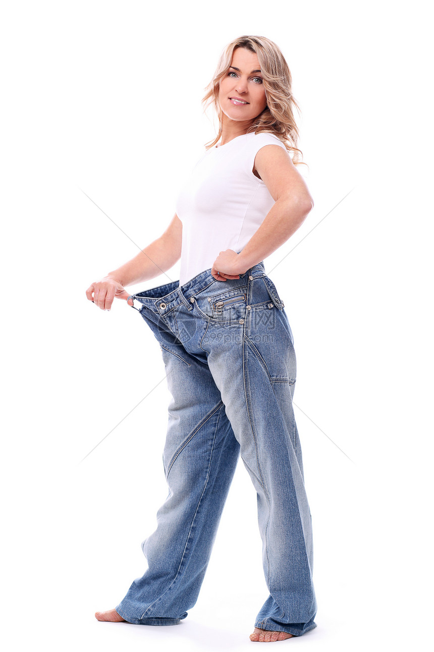 体重减瘦后穿着大裤子的年中妇女幸福数字牛仔裤衣服饮食成功工作室重量女士女性图片
