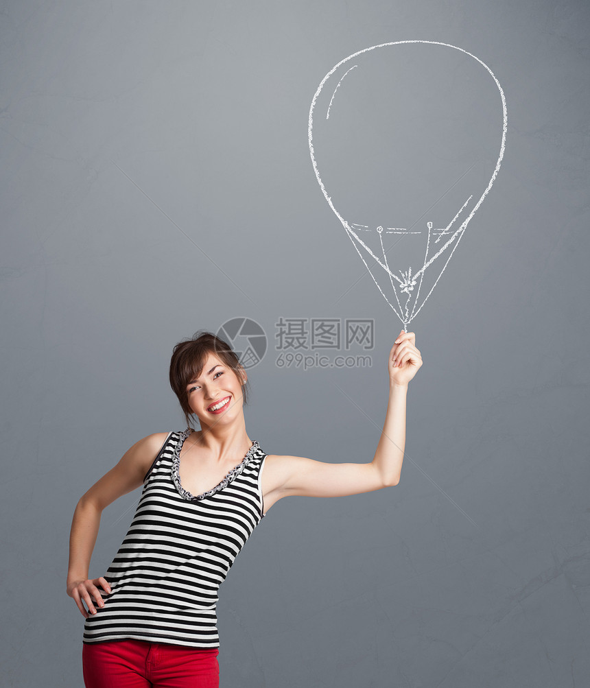 美貌的女士拿着气球画庆典女性微笑玩具派对喜悦绘画闲暇幸福演讲图片