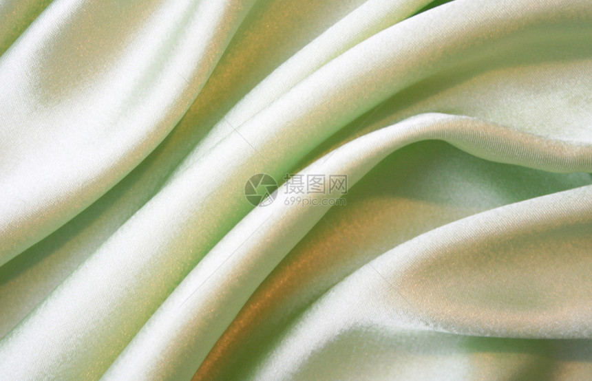 平滑优雅的绿色丝绸作为背景织物奢华纺织品布料涟漪衣服投标曲线折痕生产图片