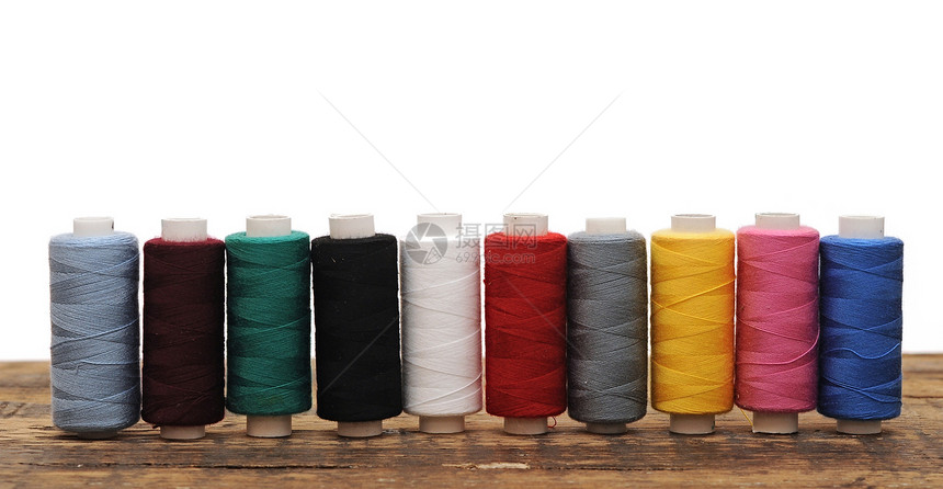 白背景刺绣的彩色纹线条生产材料尼龙细绳裁缝产品爱好纺织品棉布筒管图片