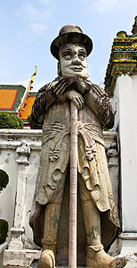 泰国曼谷Wat Pho的 人像宗教说谎警卫石头旅游雕像文化雕塑旅行地标背景图片