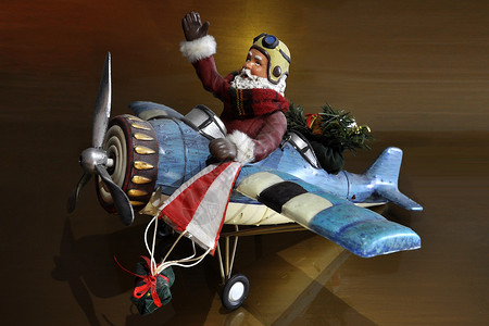 圣诞老人开飞机圣诞老人在飞机上轮子翅膀围巾金子飞行尾巴外套风镜海浪胡须背景