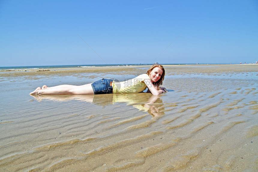 躺在北海水中的金发年轻女人游泳衣享受女士女孩晒斑乐趣女性假期泳装身体图片