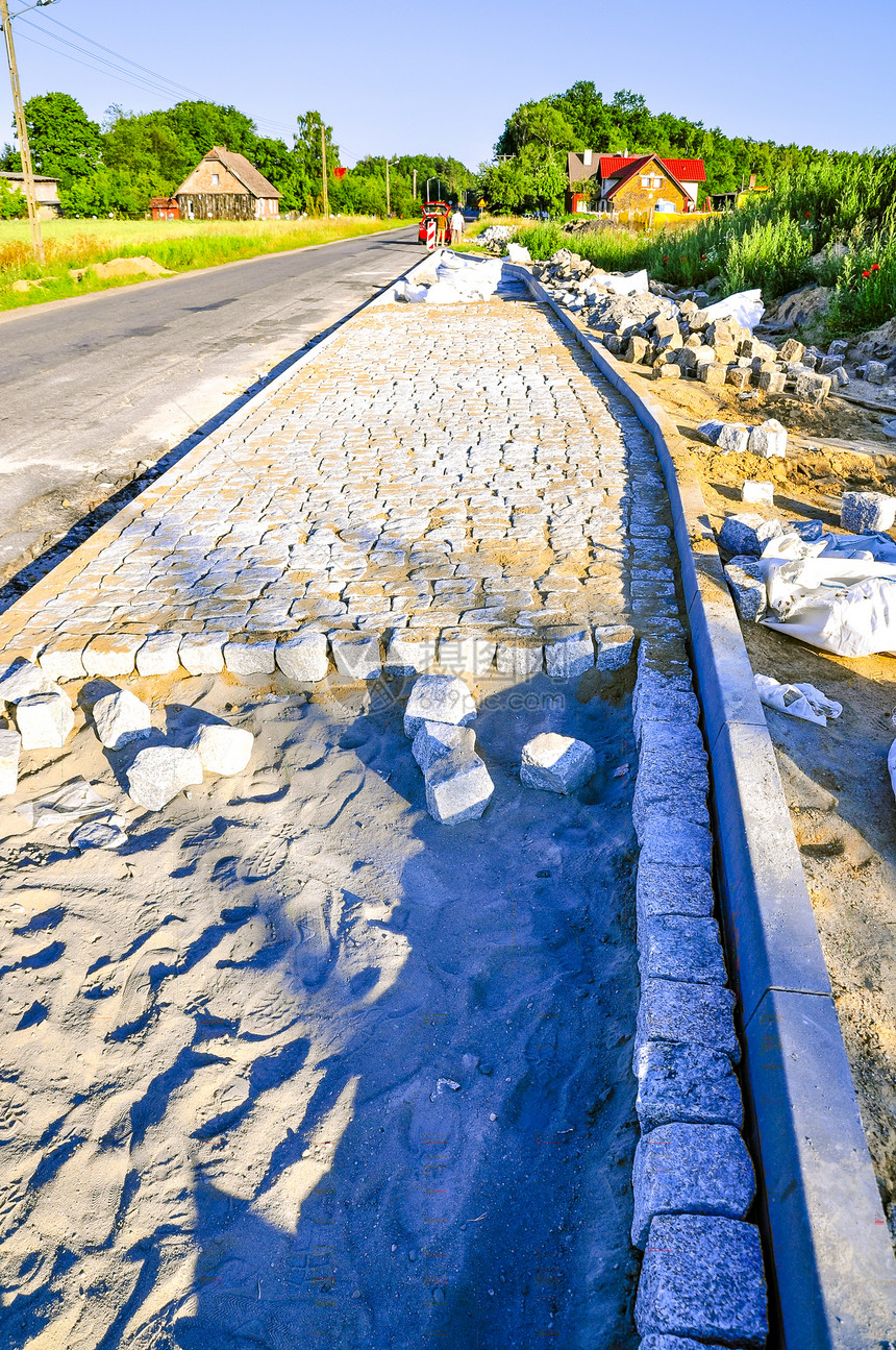 铺石头工人鹅卵石街道锤子工作地面正方形材料水泥花岗岩图片