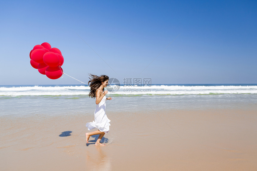 带球奔跑跑步海滩幸福女性自由蓝色快乐微笑女孩享受图片